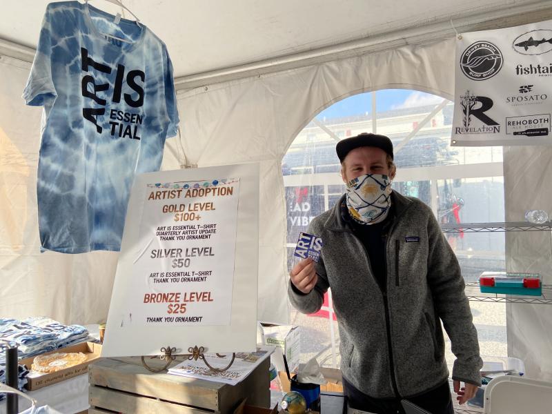 Michael Johnson of Developing Artist Collaboration sells tie-dyed T-shirts and the opportunity to adopt an artist.